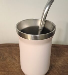Stainless steel mate gourd on a wooden table